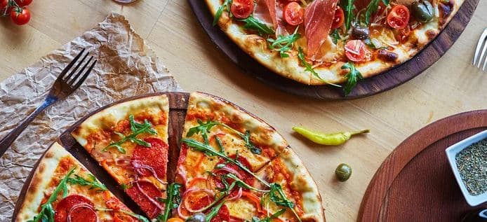 2 čerstvě nazdobené pizzy s průměrem 32 cm